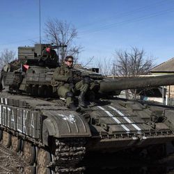 Ukrainian troops ride on a tank near the village of Luhanske, eastern Ukraine, Tuesday, Feb. 24, 2015. Ukrainian officials said they haven’t yet started pulling heavy weapons back from a frontline in eastern Ukraine because of continued rebel violations of a cease-fire deal. 