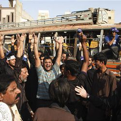 People condemn bomb attack on a bus in Karachi, Pakistan on Feb. 5, 2010.