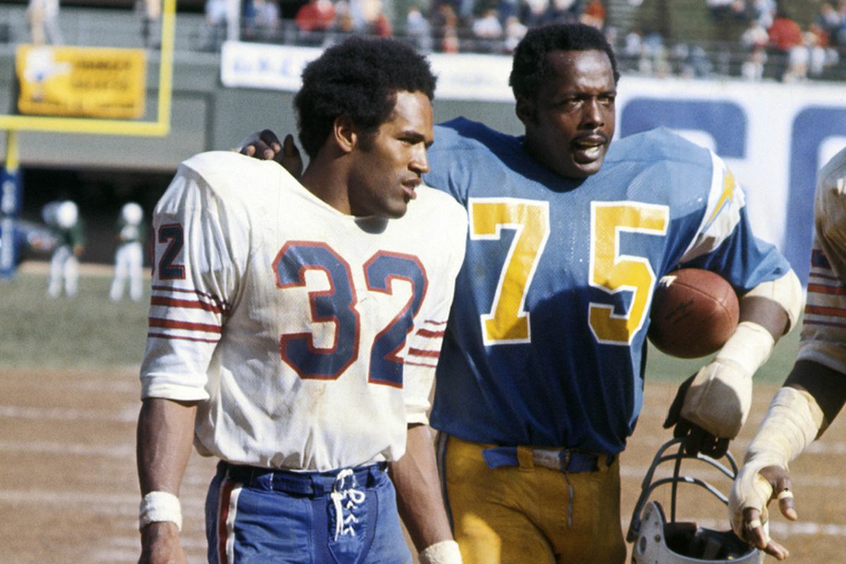 Buffalo Bills running back O.J. Simpson (32) walks off the field with San Diego Chargers defensive tackle Deacon Jones (75) at Jack Murphy Stadium on September 23, 1973