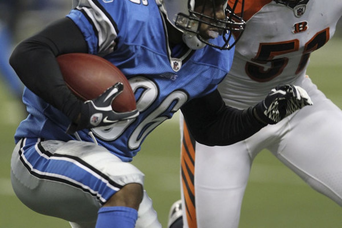 DETROIT - AUGUST 12: Paul Pratt #36 of the Detroit Lions runs for a short gain as  Dan Skuta #51 of the Cincinnati Bengals makes the stop at Ford Field on August 12, 2011 in Detroit, Michigan.  (Photo by Leon Halip/Getty Images)