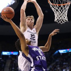 Brigham Young Cougars forward Eric Mika (12) defend a shot by Weber State Wildcats guard Cody John (5) as BYU and Weber State play at the Marriott Center in Provo on Wednesday, Dec. 7, 2016.