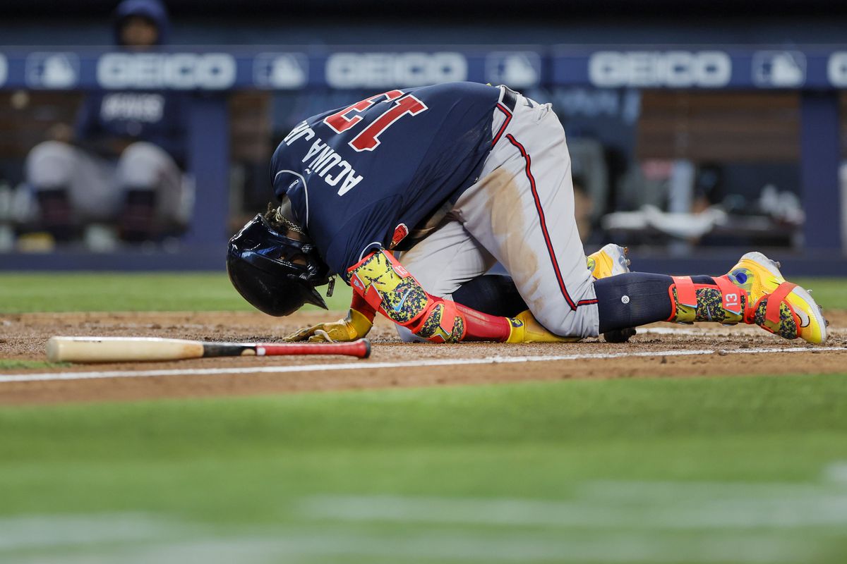 Ronald Acuna Jr. of the Atlanta Braves reacts after getting hit by a foul ball against the Miami Marlins during the sixth inning at loanDepot park on May 04, 2023 in Miami, Florida.