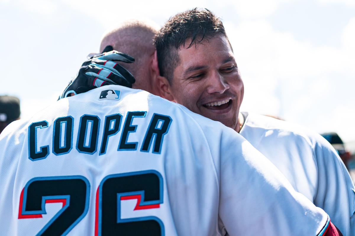 Avisail Garcia embraces Garrett Cooper after hitting a 3-run home run for the Miami Marlins