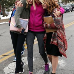 A mother, daughter and daughter's friend hug as they are reunited following a shooting incident at Mueller Park Junior High School in Bountiful on Thursday, Dec. 1, 2016. The daughter and friend are students at the school.