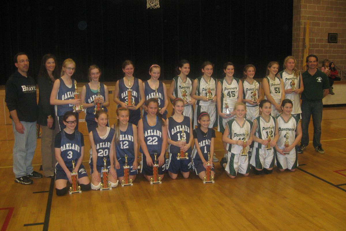 Teams from Oakland and Midland Park in New Jersey gather with their trophies after the sixth grade championship at the Blake Memorial Tournament. 