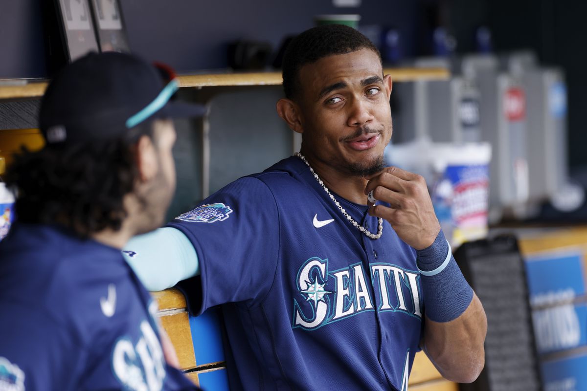 Seattle Mariners center fielder Julio Rodriguez talks to third baseman Eugenio Suarez during an MLB game against the Detroit Tigers on May 13, 2023 at Comerica Park in Detroit, Michigan.