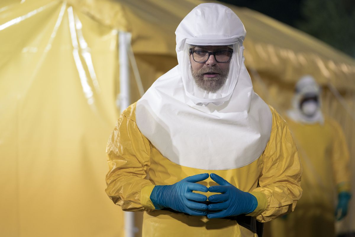 Rainn Wilson in a bright yellow Hazmat suit in Amazon’s Utopia