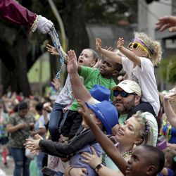 Revelers reach for beads and trinkets as the Krewe of Thoth rolls on the Uptown route in New Orleans Sunday, March 3, 2019, to the theme, ‘Thoth Salutes the Greats.’ Douglas Rushing reigned as king and Madison Komnecker as queen over 1,800 male riders on 39 floats. Founded in 1947, the Krewe of Thoth is named for the Egyptian Patron of Wisdom and Inventor of Science, Art and Letters.    (Scott Threlkeld/The Advocate via AP)