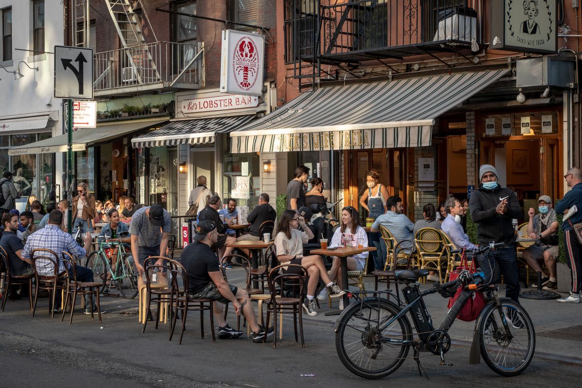 Tables and chairs are set outside restaurants on Lafayette St.