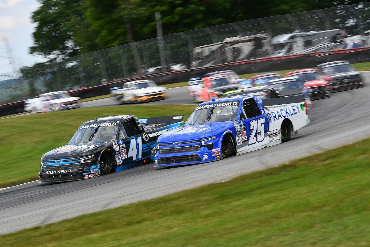 Justin Marks, driver of the #41 Worldwide Express Chevrolet, and Matt DiBenedetto, driver of the #25 Rackley Roofing/WAR Shocks Chevrolet, race during the NASCAR Camping World Truck Series O’Reilly Auto Parts 150 at Mid-Ohio Sports Car Course on July 09, 2022 in Lexington, Ohio.