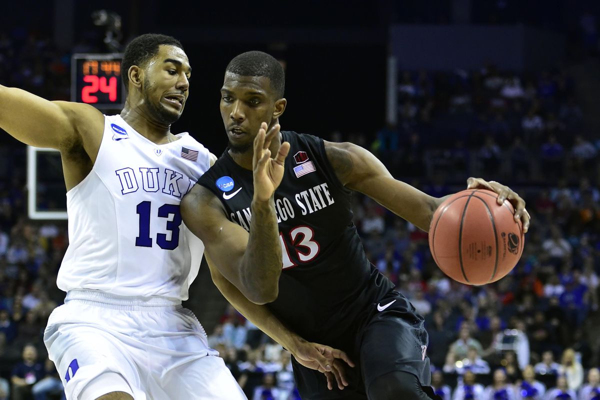 Mar 22, 2015; Charlotte, NC, USA; San Diego State Aztecs forward Winston Shepard (13) drives to the basket against Duke Blue Devils guard Matt Jones (13) during the second half in the third round of the 2015 NCAA Tournament at Time Warner Cable Arena