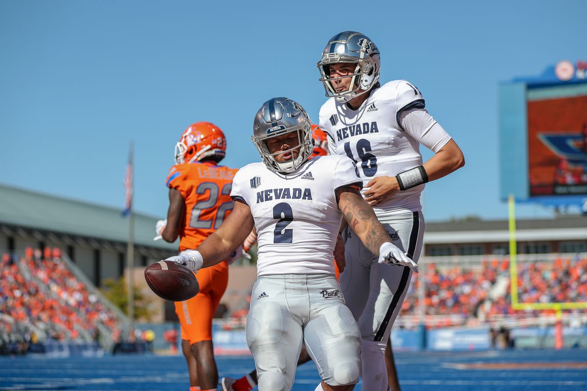 Running back Devonte Lee #2 and quarterback Nate Cox #16 of the Nevada Wolf Pack during first half action against the Boise State Broncos on October 2, 2021 at Albertsons Stadium in Boise, Idaho.