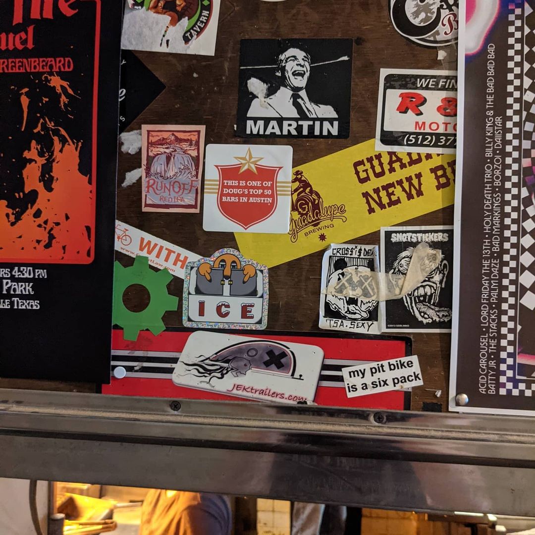 A bunch of stickers on a wall.