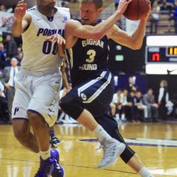 BYU's Tyler Haws (3) drives against Portland's Kevin Bailey (00) during the first half of an NCAA college basketball game in Portland, Ore., Thursday Feb. 26, 2015.