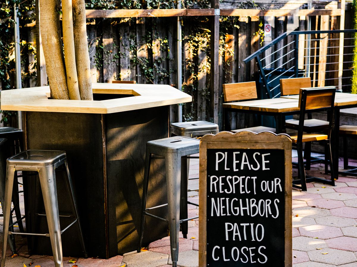 A patio space with chairs, tables, and brick at MacLeod Ale Brewing Co. in Highland Park, California.