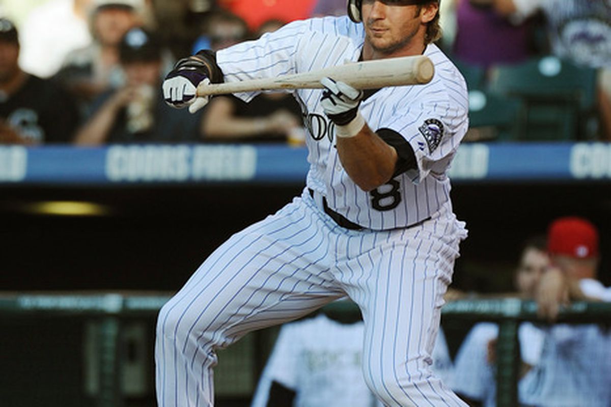 DENVER, CO - JULY 2:  Charlie Blackmon #8 of the Colorado Rockies bunts for a base hit during the game against the Kansas City Royals at Coors Field on July 2, 2011 in Denver, Colorado.  (Photo by Garrett W. Ellwood/Getty Images)