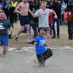 Participants jump into a 34-degree Lake Michigan for the Chicago Polar Plunge. | Victor Hilitski/For the Sun-Times