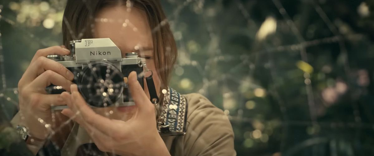 Cassandra Webb’s mom taking a picture of a spider in a still from Madame Web