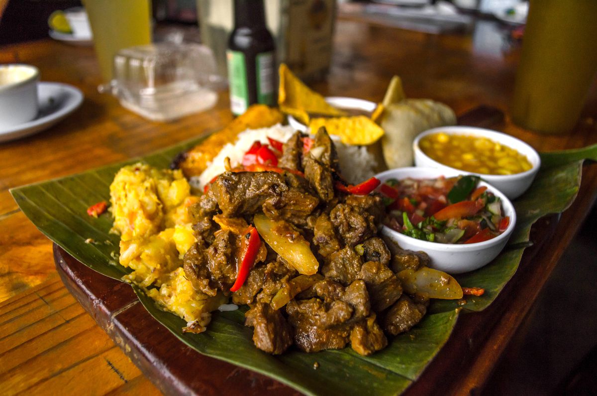 A banana leaf is spread with a mixture of traditional Costa Rican foods. 