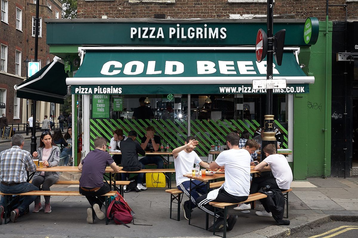 Diners sit outside Pizza Pilgrims