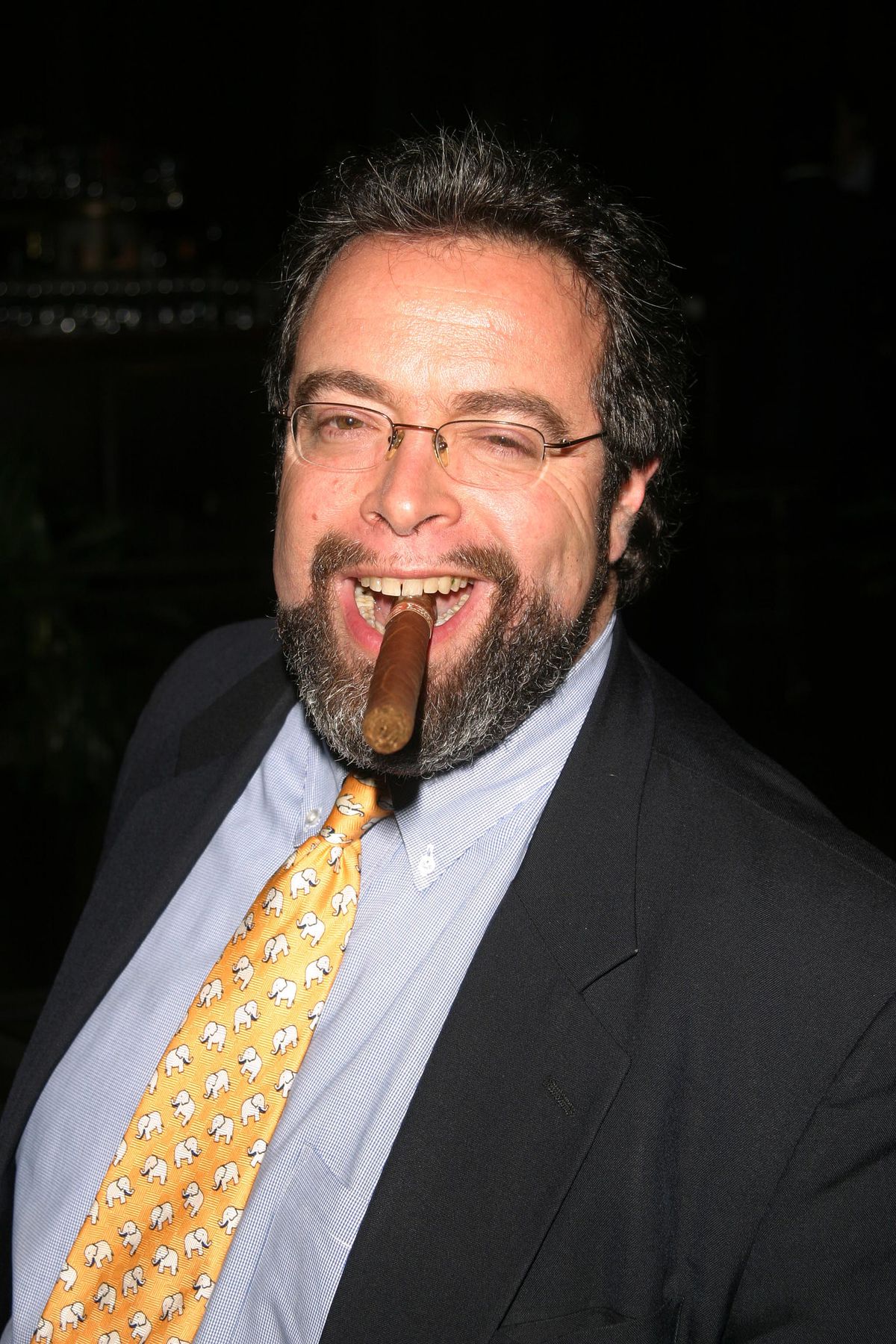 Drew Nieporent smiles with a cigar hanging out of his mouth in 2003.