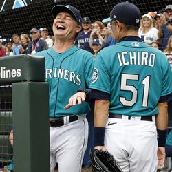 SEATTLE, WASHINGTON - AUGUST 26: Former Seattle Mariner Ichiro Suzuki reacts with Manager Scott Servais #9 after catching the ceremonial first pitch from Iris Skinner “Ichiro Girl” (not pictured) before the game between the Seattle Mariners and the Cleveland Guardians at T-Mobile Park on August 26, 2022 in Seattle, Washington. Ichiro Suzuki will be inducted into the Mariners Hall of Fame during a pre-game ceremony on Saturday, Aug. 27 against the Cleveland Guardians. He will become the 10th member of the Mariners Hall of Fame.