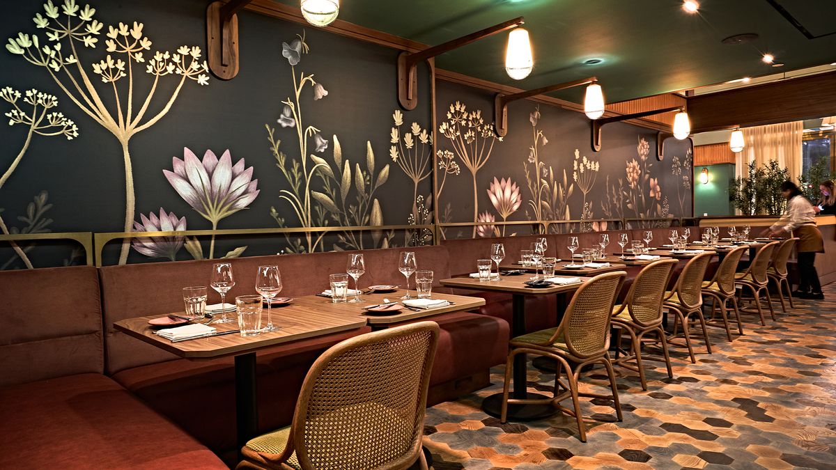 A wallpapered dining room at a newly opened restaurant.