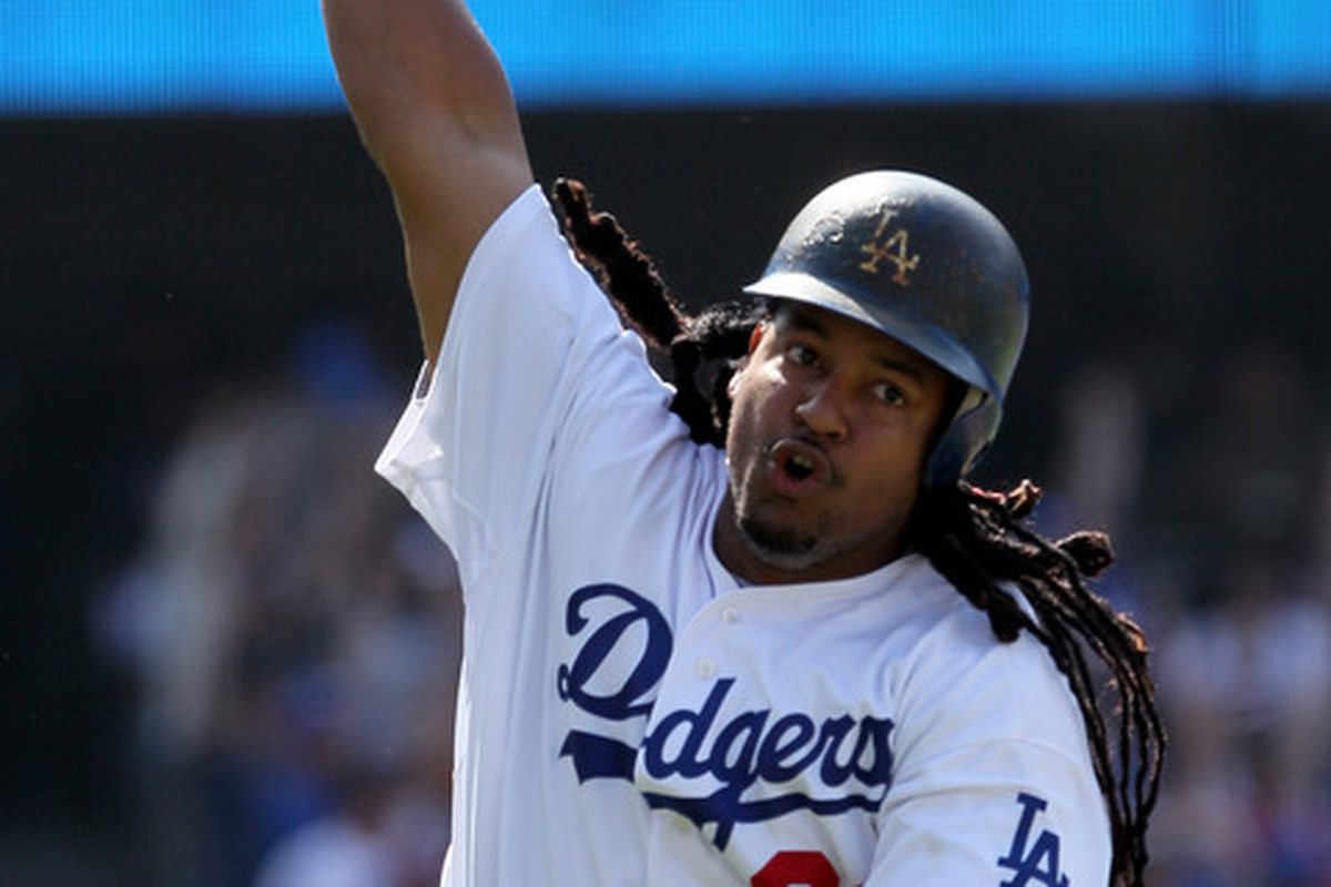 Manny Ramirez, held out of the starting lineup for the second straight game with a strained right calf, delivered a pinch-hit two-run home run to give the Dodgers a 2-1 victory over the Giants