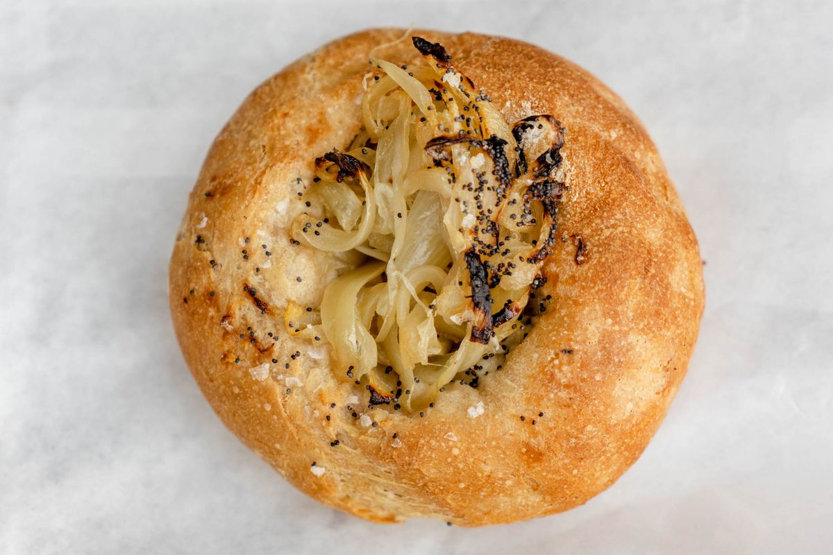 A round bun with caramelized onion on top.