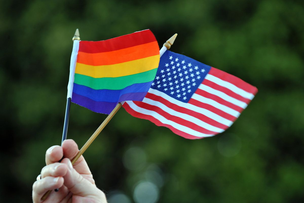 The LGBTQ pride flag with the US flag.