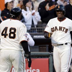 San Francisco Giants' Pablo Sandoval (48) celebrates with Joaquin Arias after Sandoval scored on a double by Buster Posey during the first inning of a baseball game on Monday, April 22, 2013, in San Francisco. 