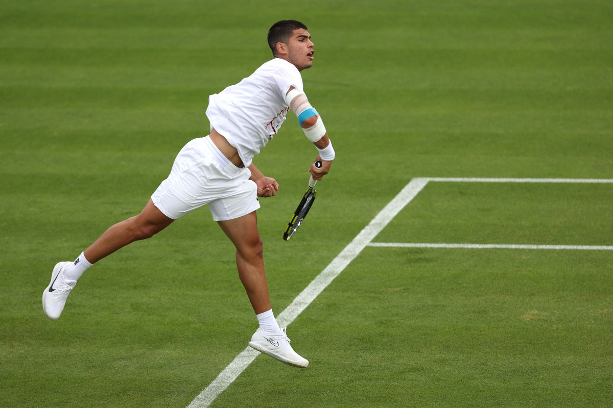 Carlos Alcaraz of Spain serves in a practice session ahead of The Championships Wimbledon 2022 at All England Lawn Tennis and Croquet Club on June 24, 2022 in London, England.