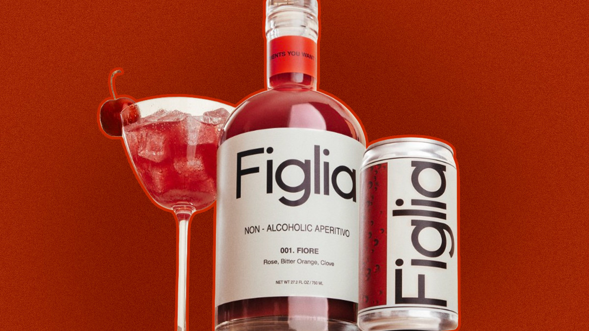 A cocktail glass filled with a red liquid, a bottle of Figlia, and a can of Figlia