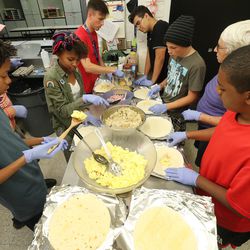 Teen volunteers assemble breakfast burritos at the Sugarhouse Boys and Girls Club to feed the homeless in Salt Lake City, Utah, on Thursday, July 18, 2019.