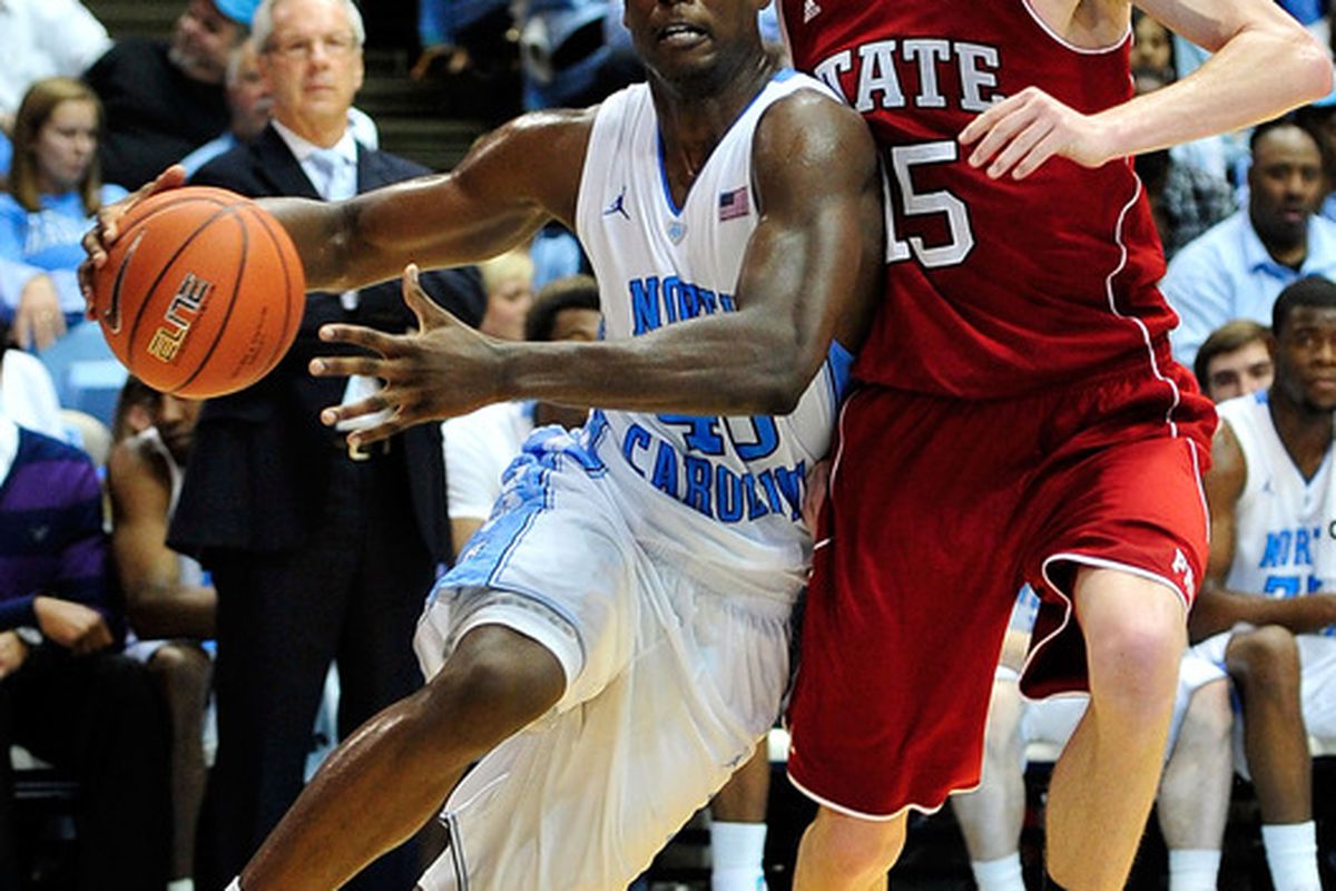 Harrison Barnes drives the baseline against Scott Wood #15 of the North Carolina State Wolfpack during play at the Dean Smith Center. North Carolina won 74-55.