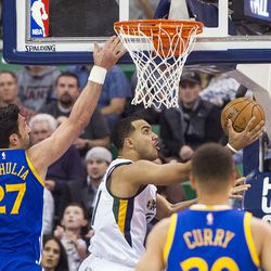 Utah center Rudy Gobert (27) shoots a layup past Golden State center Zaza Pachulia (27) during the second half of an NBA basketball game in Salt Lake City on Thursday, Dec. 8, 2016. Golden State defeated Utah with a final score of 106-99.