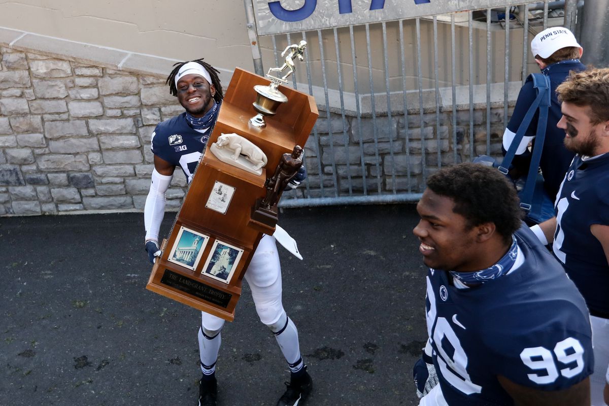 Dec 12, 2020; University Park, Pennsylvania, USA; Penn State Nittany Lions wide receiver Benjamin Wilson (84) carries the Land-Grant trophy into the team tunnel following the completion of the game against the Michigan State Spartans at Beaver Stadium. Penn State defeated Michigan State 39-24.