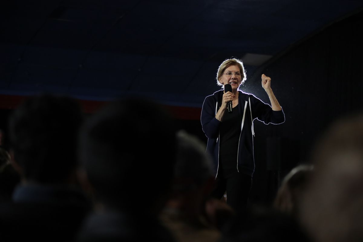 Elizabeth Warren on stage surrounded by a crowd at a campaign stop in Des Moines, Iowa in November 2019.