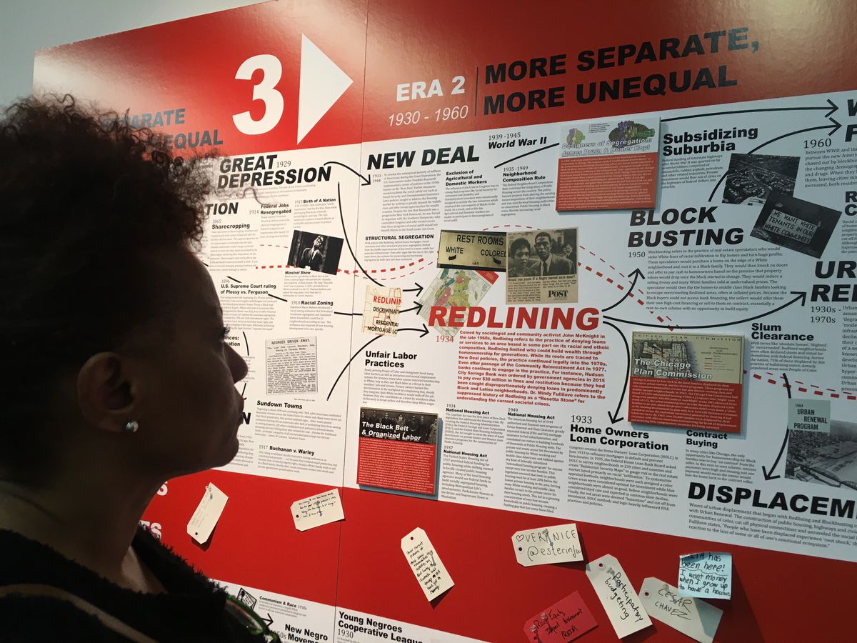 Sheila Lewis studies the exhaustive timeline of redlining at The National Public Housing Museum on April 4. | Carlos Ballesteros/Sun-Times