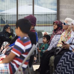 Akil Kasim, 2, sits with his grandmother during MOSAIC Inter-Faith Ministries' celebration of World Refugee Day in Millcreek on Thursday, June 20, 2019. Thursday's celebration involved prayers from many different religions followed by a feast. Akil and his family are refugees from Syria.