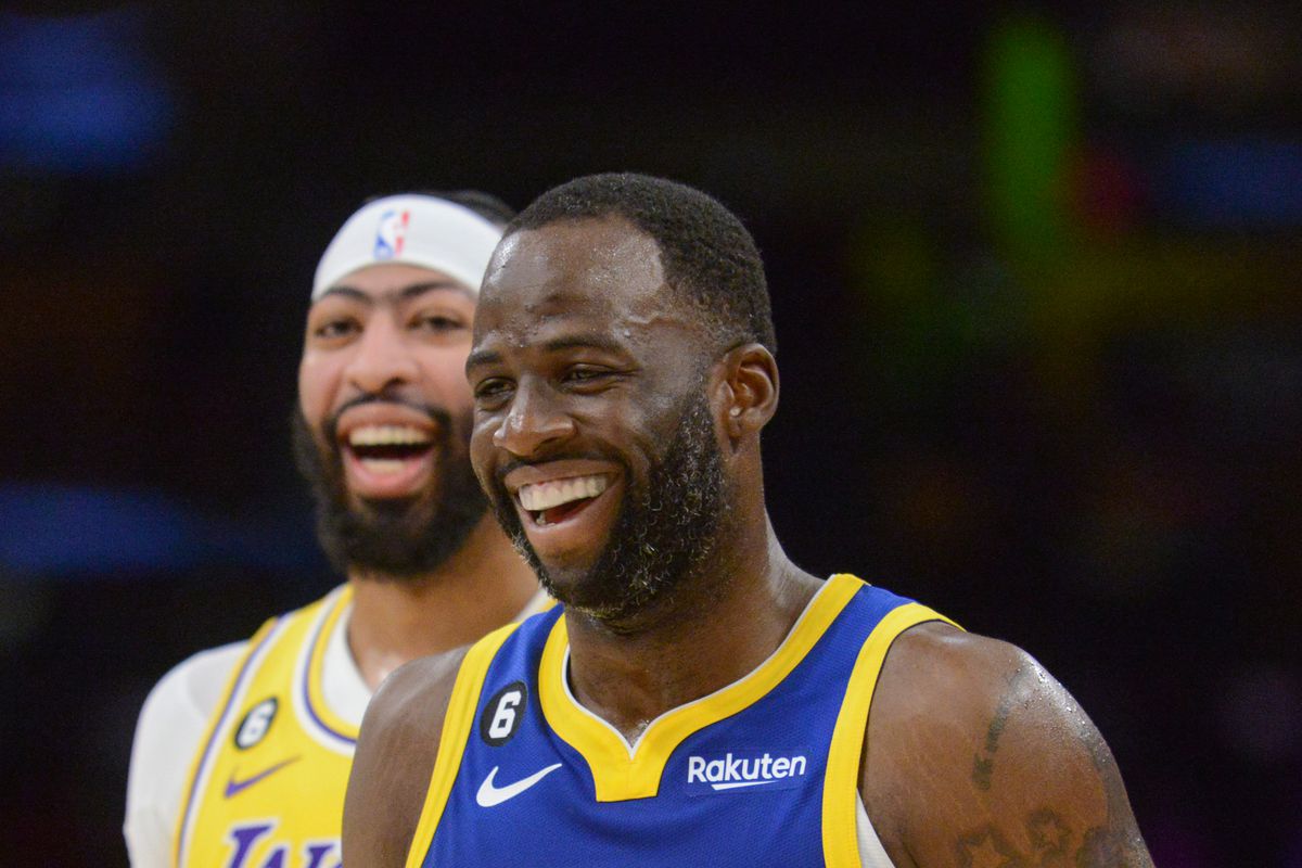Draymond Green smiling with Anthony Davis smiling behind him