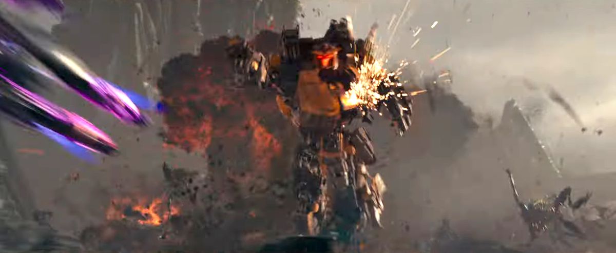 A Transformer with purple neon legs zips off screen as it’s chased by a yellow transformer with an explosion in the background in Transformers: Rise of the Beasts
