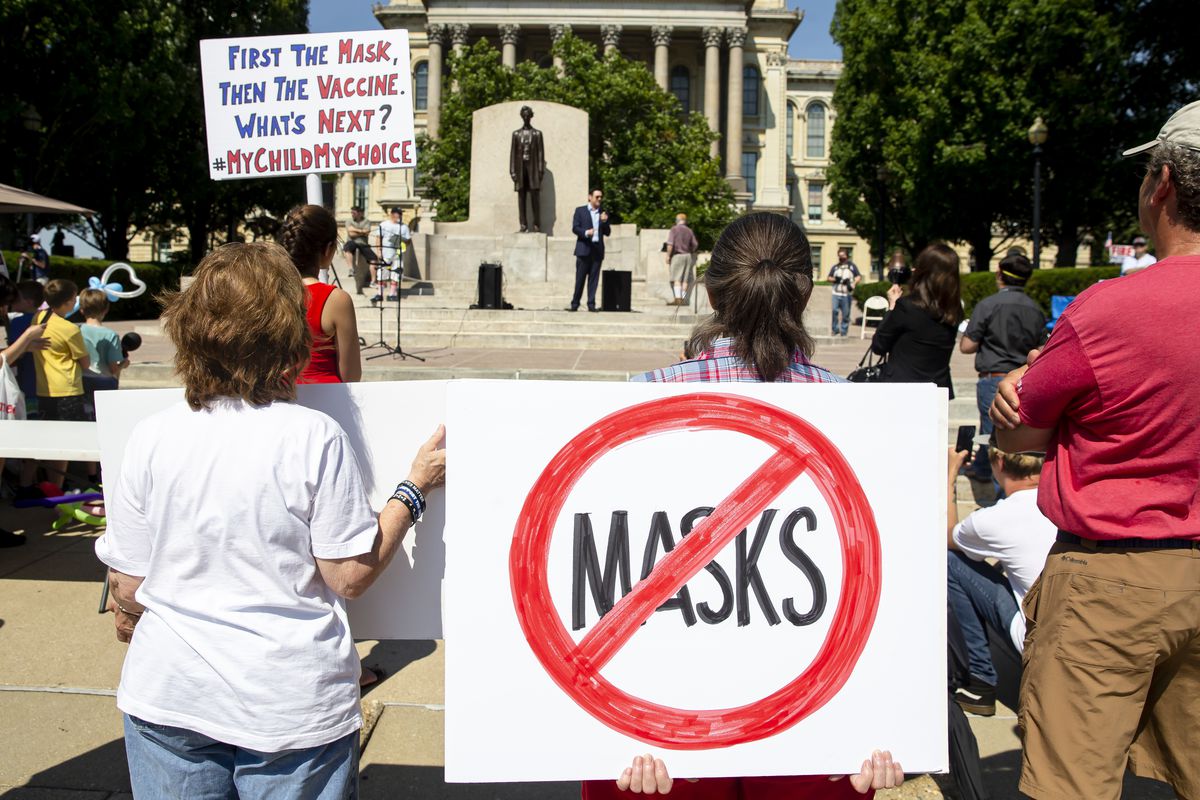 Protesters listen to William Kelly, host of the Citizen Kelly Show, as he speaks about suing Gov. JB Pritzker over COVID-19 restrictions during the “Million Unmasked March” at the Illinois State Capitol, Saturday, July 25, 2020, in Springfield, Ill. 