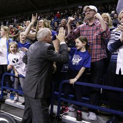 BYU coach Dave Rose, center, celebrates with fans after BYU defeated No. 1 Gonzaga 79-71 in an NCAA college basketball game in Spokane, Wash., Saturday, Feb. 25, 2017. (AP Photo/Young Kwak)