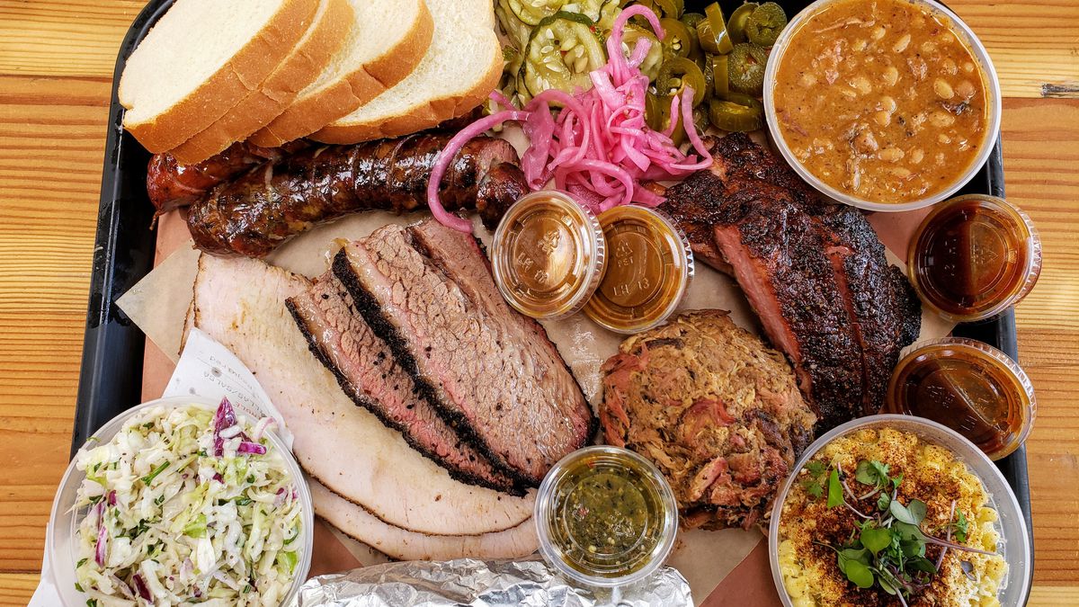 A platter of barbecued meats and sides from Moo’s Craft Barbecue