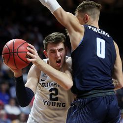 Brigham Young Cougars guard Zac Seljaas (2) slams into San Diego Toreros forward Isaiah Pineiro (0) on an attempted shot as the BYU Cougars and San Diego Toreros play in WCC tournament action at the Orleans Arena in Las Vegas on Saturday, March 9, 2019. San Diego won 80-57.