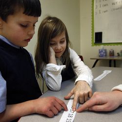 Teacher Shannon Garner administers a math test with Kindergarten students Blake Anderson and Rachel Coy at Legacy Preparatory Academy in North Salt Lake City Tuesday, Feb. 24, 2015.