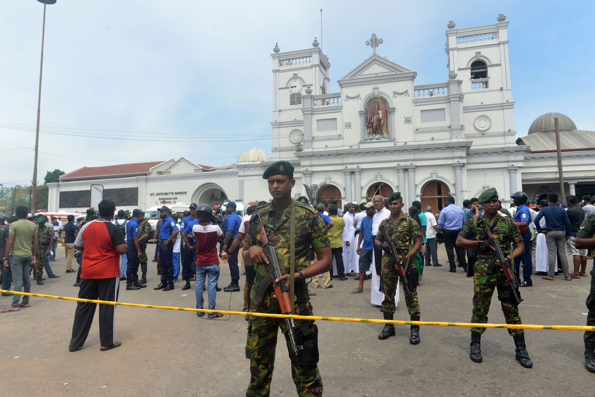 Sri Lankan military and police forces stand guard outside of Colombo’s St. Anthony’s Shrine.