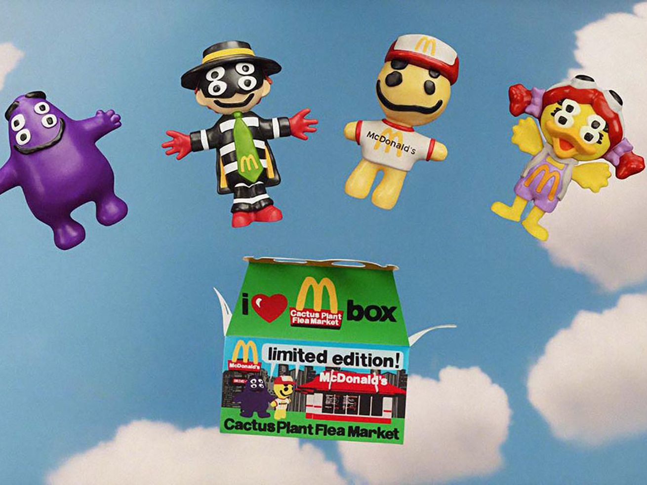 Happy Meal box with four different toys above it.