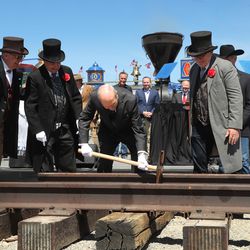 President Russell M. Nelson of The Church of Jesus Christ of Latter-day Saints, center, drives the "Utah copper spike" during the 150th anniversary celebration of the transcontinental railroad at the Golden Spike National Historical Park at Promontory Summit on Friday, May 10, 2019.